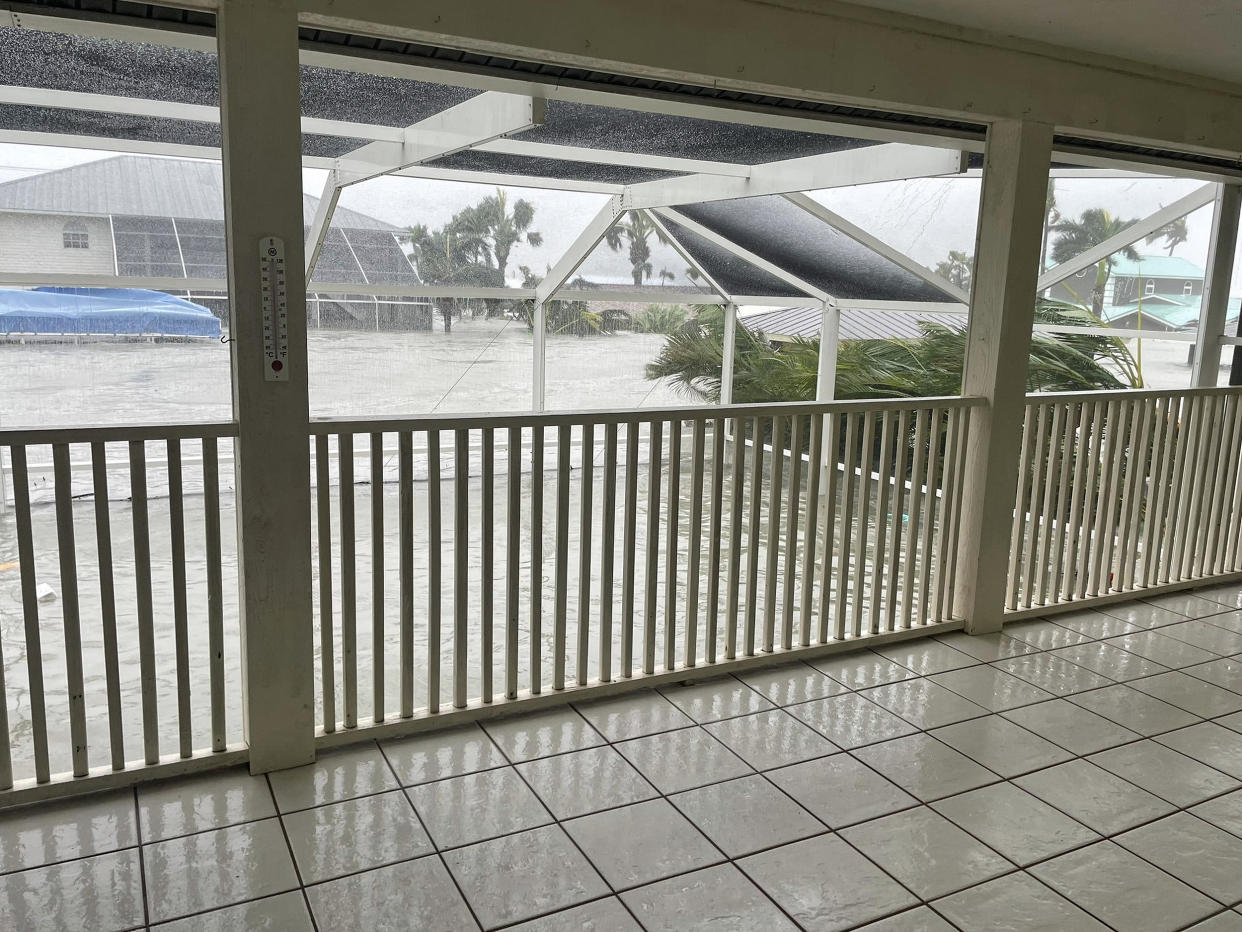 A photo of Beth Booker's childhood home in Fort Myers, Florida as the floodwaters rose. The first story is now completely submerged.  (Courtesy Beth Booker)