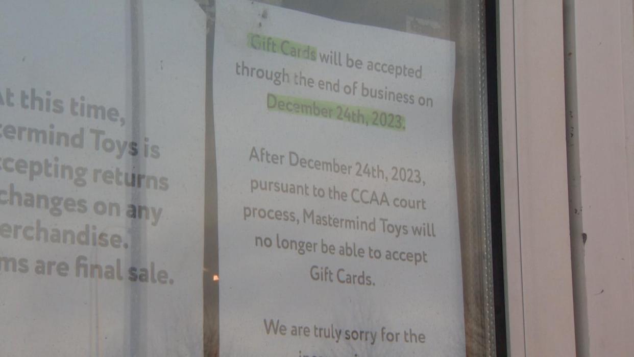 Signs were put up on Mastermind Toys' storefronts shortly before Christmas weekend saying gift cards would no longer be accepted past Dec. 24. (Roger Cosman/CBC News - image credit)