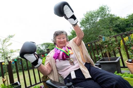 Woman wearing black boxing gloves 