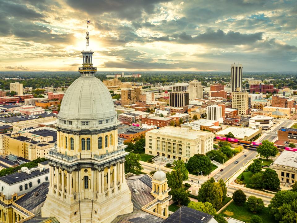 Aerial view of the Illinois State Capitol dome and Springfield skyline.