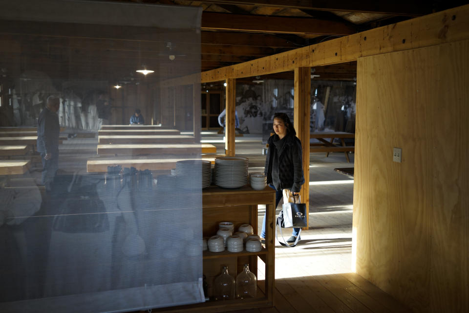 Lori Matsumura visits a replica mess hall at the Manzanar National Historic Site near Independence, Calif., Monday, Feb. 17, 2020. Matsumura's father and his family were among the more than 10,000 Japanese Americans imprisoned at the Manzanar War Relocation Center during World War II. Her grandfather, Giichi Matsumura, died when he left the camp to explore the nearby high Sierra in 1945. Hikers discovered his mountainside grave and unearthed the skeleton in 2019, leading authorities to retrieve the bones and return them to the Matsumura family. (AP Photo/Brian Melley)