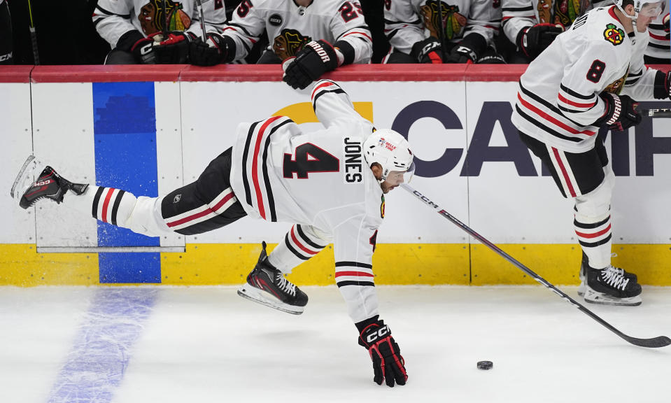 Chicago Blackhawks defenseman Seth Jones flies on to the ice after drawing a tripping penalty on Colorado Avalanche center Andrew Cogliano in the first period of an NHL hockey game, Monday, March 4, 2024, in Denver. (AP Photo/David Zalubowski)