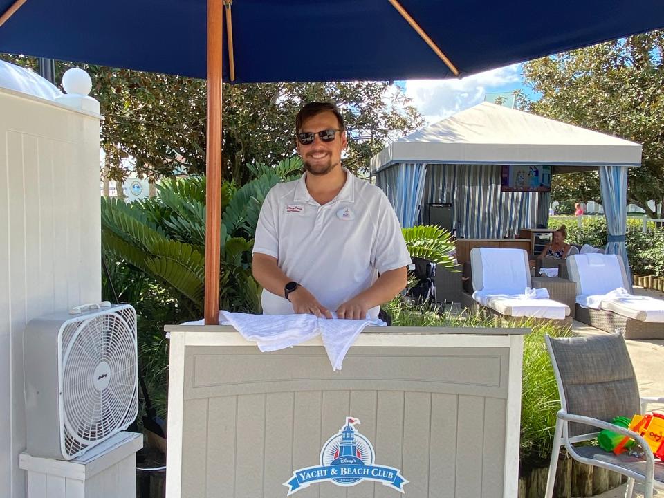 attendant behind the host stand at teh private cabanas at disney world's yacht club resort