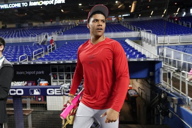 Washington Nationals right fielder Juan Soto looks on in the dugout prior  to an opening day baseball game against the New York Mets at Nationals  Park, Thursday, April 7, 2022, in Washington. (
