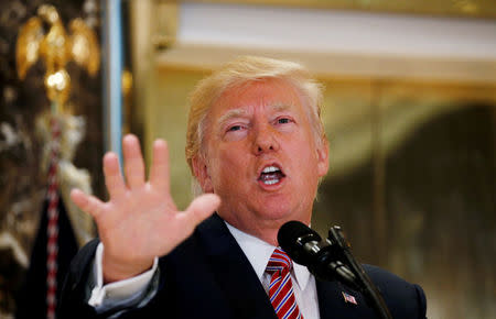 U.S. President Donald Trump speaks about the violence, injuries and deaths at the "Unite the Right" rally in Charlottesville as he talks to the media in the lobby of Trump Tower in Manhattan, New York, U.S., August 15, 2017. REUTERS/Kevin Lamarque