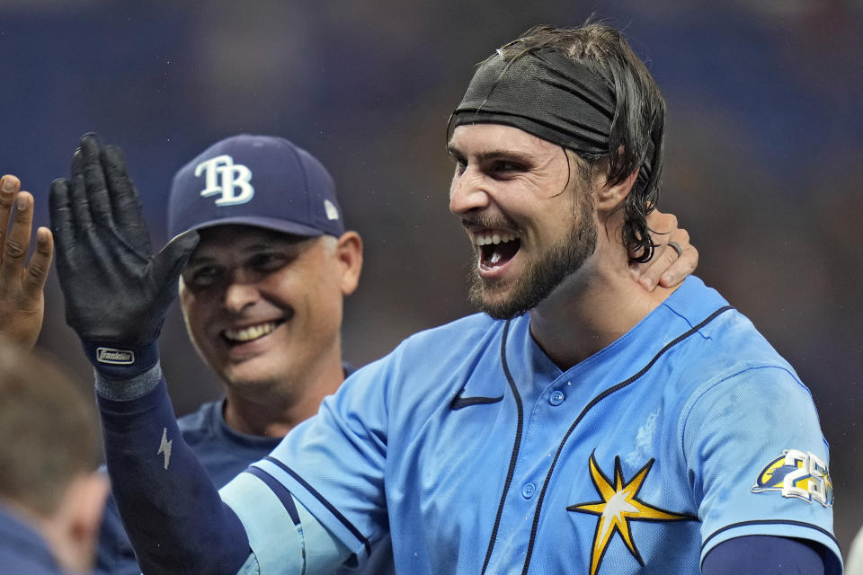 Tampa Bay Rays' Josh Lowe, right, celebrates with teammates, including manager Kevin Cash, left, after his walk-off single off Toronto Blue Jays relief pitcher Jordan Romano during the ninth inning of a baseball game Saturday, Sept. 23, 2023, in St. Petersburg, Fla. (AP Photo/Chris O'Meara)