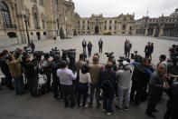 The press covers a statement by Peru's new President Dina Boluarte at the government palace in Lima, Peru, Thursday, Dec. 8, 2022. Peru's Congress voted to remove President Pedro Castillo from office Wednesday and replace him with the vice president, Boluarte, shortly after Castillo tried to dissolve the legislature ahead of a scheduled vote to remove him. (AP Photo/Fernando Vergara)