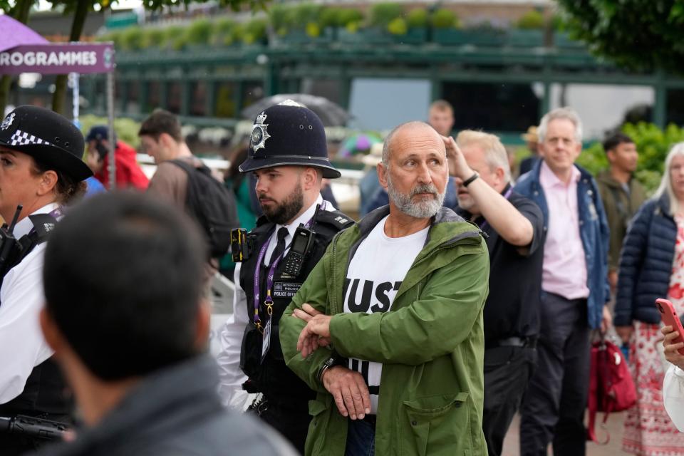 A Just Stop Oil protester is led away (AP)