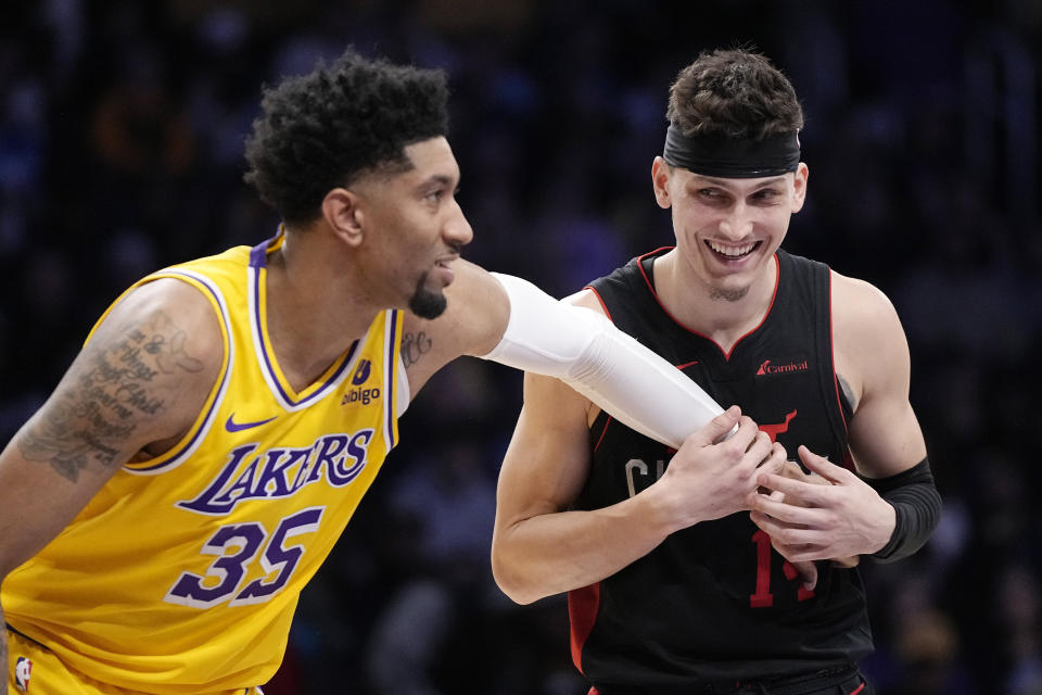 Los Angeles Lakers forward Christian Wood, left, appears to tickle Miami Heat guard Tyler Herro as they wait for a free throw during the second half of an NBA basketball game Wednesday, Jan. 3, 2024, in Los Angeles. (AP Photo/Mark J. Terrill)