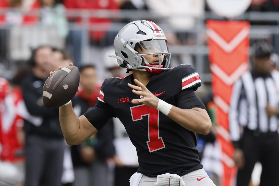 FILE - Ohio State quarterback C.J. Stroud drops back to pass during an NCAA college spring football game Saturday, April 16, 2022, in Columbus, Ohio. When the NCAA lifted restrictions on players profiting from their name, image and likeness, it created instant millionaires of elite college football players like Ohio State quarterback C.J. Stroud and Alabama quarterback Bryce Young. (AP Photo/Jay LaPrete, File)