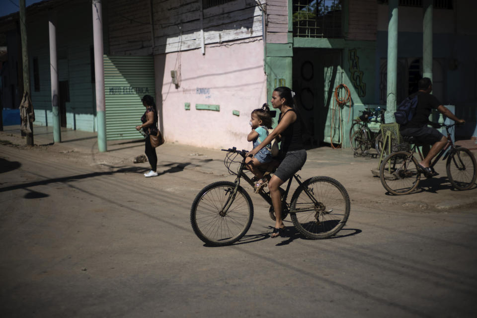 People cycle through San Nicolas, Cuba, Friday, May 19, 2023. Due to the ongoing fuel shortage, most people ride bicycles or horse carts to travel short distances. (AP Photo/Ramon Espinosa)