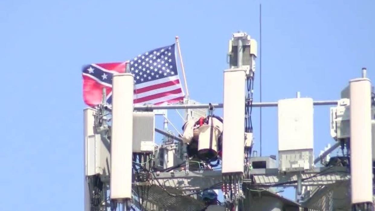 An Iconic Communications worker hung up a half-American and half-Confederate flag from a cellphone tower in Omaha, Neb. (Credit:KMTV)