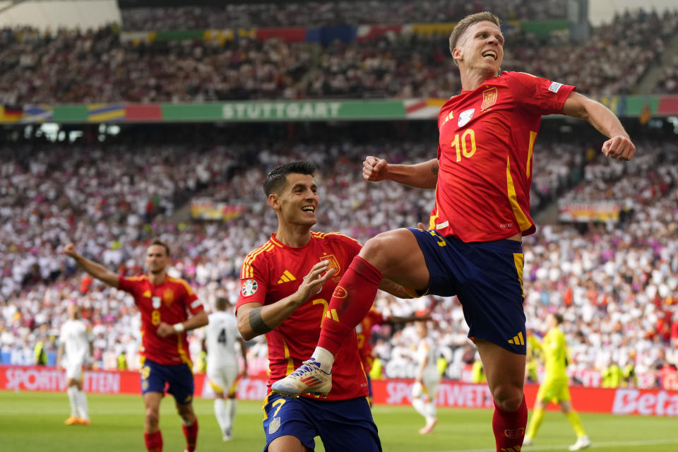 Spain's Dani Olmo, right, celebrates with Spain's Alvaro Morata after scoring his sides first goal during a quarter final match between Germany and Spain at the Euro 2024 soccer tournament in Stuttgart, Germany, Friday, July 5, 2024. (AP Photo/Manu Fernandez)