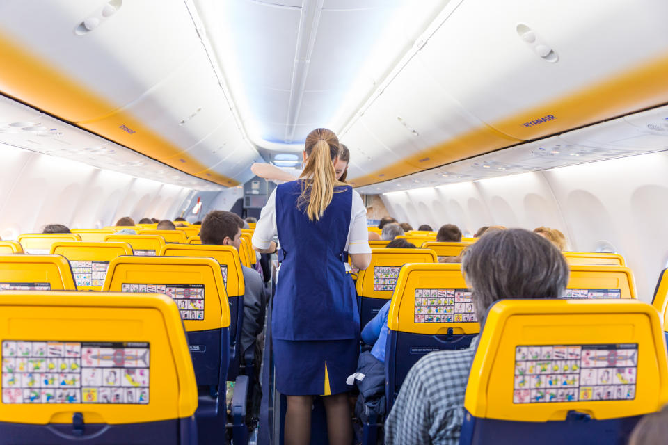 Valencia, Spain - Dec 14, 2017: Interior view of stewardess serving passangers on Ryanair low-cost flight on 14th of December, 2017 on a flight from Trieste to Valencia.