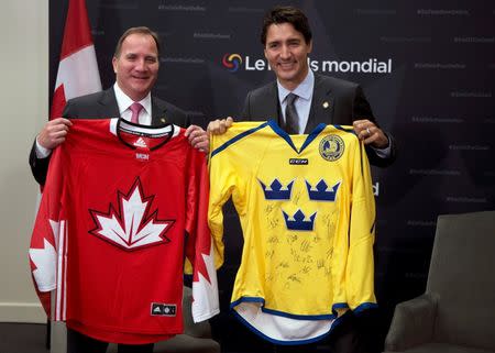 Canada's Prime Minister Justin Trudeau and Sweden's Prime Minister Stefan Lofven exchange hockey jerseys before a bilateral meeting during the Fifth Replenishment Conference of the Global Fund to Fight AIDS, Tuberculosis, and Malaria in Montreal, Quebec, Canada September 17, 2016. REUTERS/Christinne Muschi