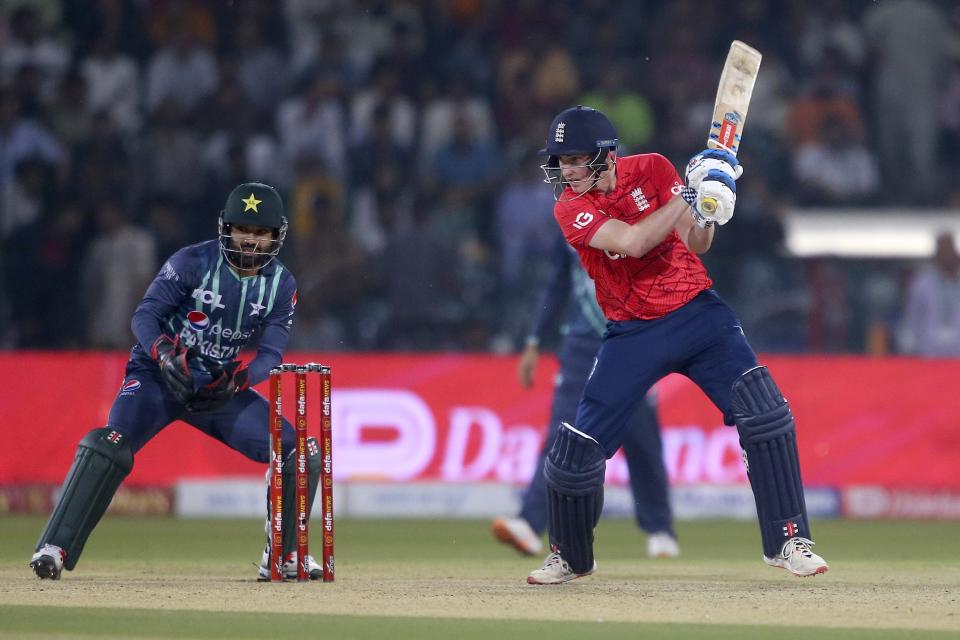 England's Harry Brook, right, bats as Pakistan's Mohammad Rizwan watches during the seventh twenty20 cricket match between Pakistan and England, in Lahore, Pakistan, Sunday, Oct. 2, 2022. (AP Photo/K.M. Chaudary)