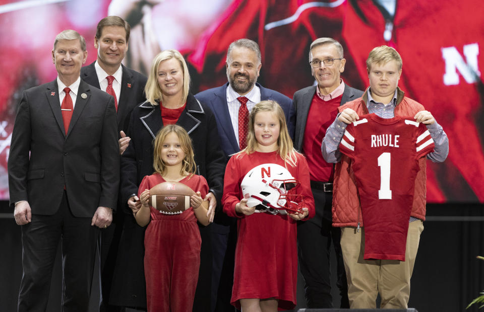 Back row from left, University of Nebraska president Ted Carter, Nebraska athletic director Trev Alberts, Julie Rhule, new Nebraska NCAA college football coach Matt Rhule and University of Nebraska-Lincoln chancellor Ronnie Green pose for photos along with Rhule's children, front from left, Leona, 7, Vivienne, 9, and Bryant, 18, following an introductory press conference, Monday, Nov. 28, 2022, in Lincoln, Neb. (AP Photo/Rebecca S. Gratz)
