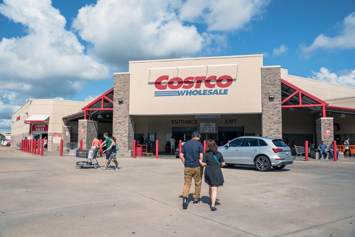 Costco Wholesale storefront with customers entering.