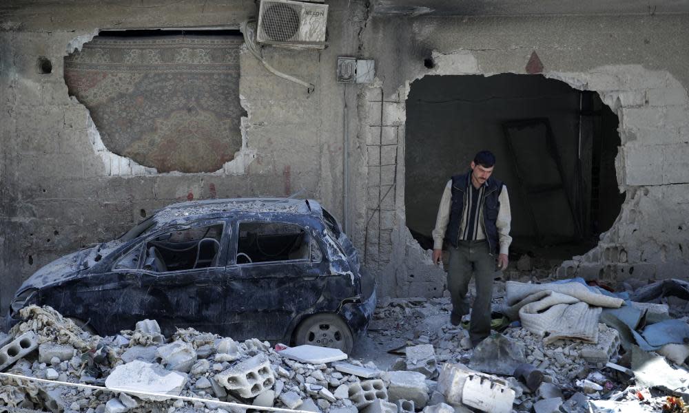 A man walks near the site of the chemical weapons attack in Douma, Syria