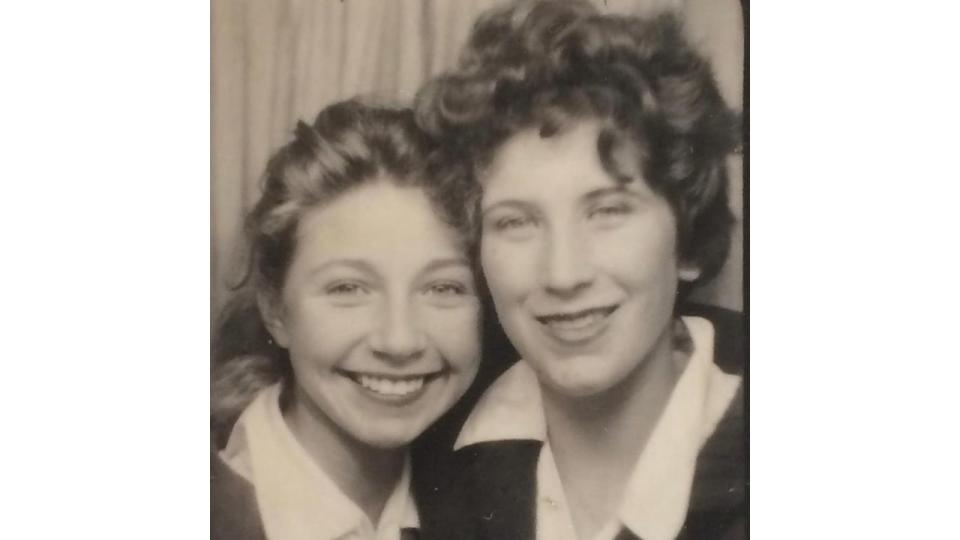 A young Zoe Ball with curly hair next to her mother