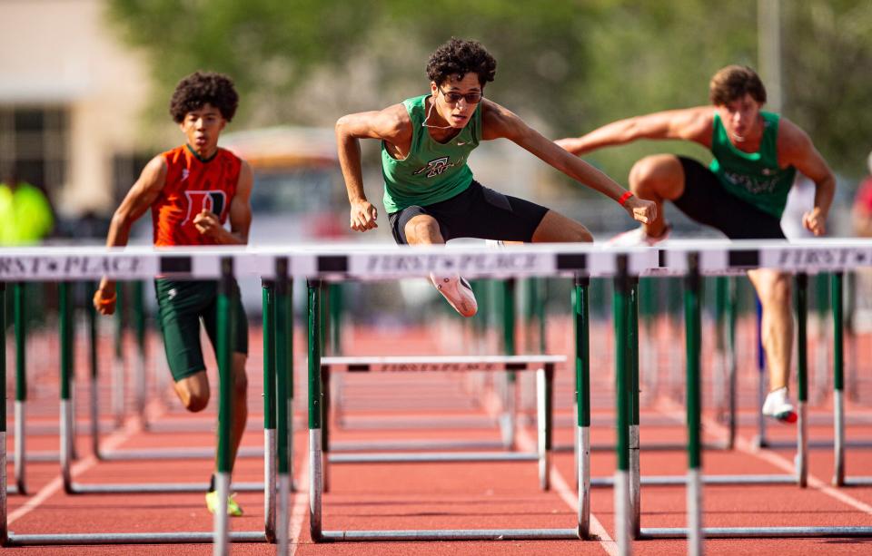 Thiago Lopes from Fort Myers High School  leads the 100 meter hurdles during the FHSAA 3A District 11 track & field meet at Dunbar High School on April 20, 2023. He won. 