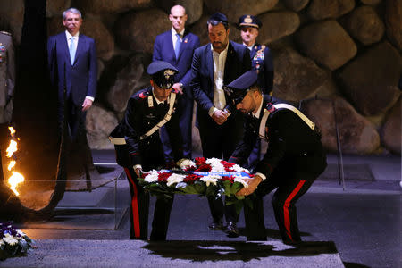 Italian Deputy Prime Minister and right-wing League party leader Matteo Salvini (C) takes part in a wreath-laying ceremony commemorating the six million Jews killed by the Nazis in the Holocaust, in the Hall of Remembrance at Yad Vashem World Holocaust Remembrance Center in Jerusalem December 12, 2018. REUTERS/Ammar Awad