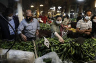 People wearing face masks to help prevent the spread of the coronavirus shop at the old grand bazaar of the city of Zanjan, some 330 kilometers (205 miles) west of the capital Tehran, Iran, Sunday, July 5, 2020. Iran on Sunday instituted mandatory mask-wearing as fears mount over newly spiking reported deaths from the coronavirus, even as its public increasingly shrugs off the danger of the COVID-19 illness it causes. (AP Photo/Vahid Salemi)