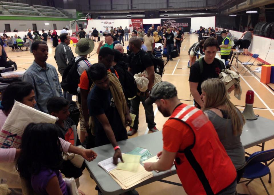 Evacuees line up to register