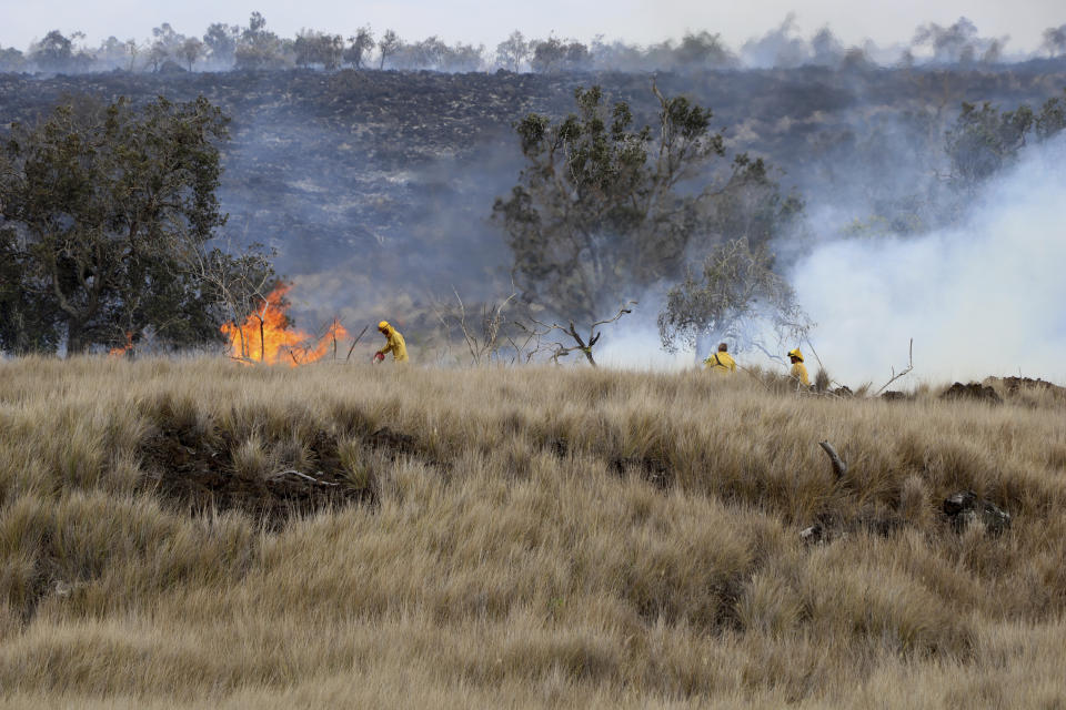 This photo provided by the Hawaii Department of Land and Natural Resources shows a large wildfire on Thursday, Aug. 11, 2022, in a rural area of Hawaii's Big Island is not threatening any homes, but high winds and extremely dry conditions are making it difficult for crews to contain the blaze. (Hawaii Department of Land and Natural Resources via AP)