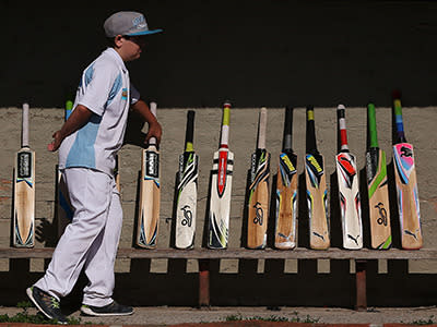  Langwarrin cricketers stand their bats up in respect for Phillip Hughes before their under-12's match