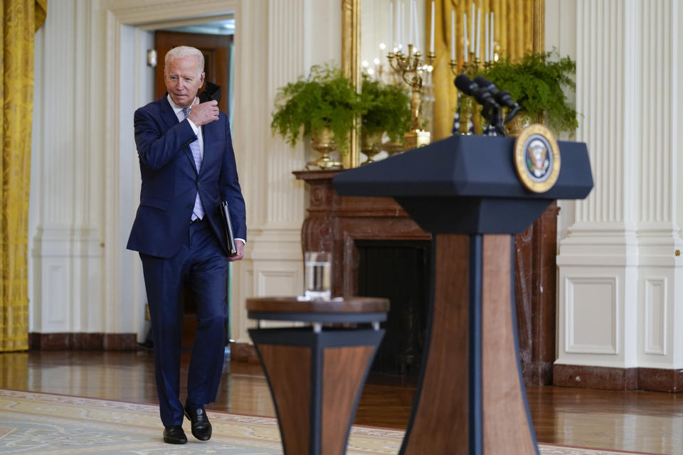 President Joe Biden removes his face mask as he arrives to speak about prescription drug prices and his "Build Back Better" agenda from the East Room of the White House, Thursday, Aug. 12, 2021, in Washington. (AP Photo/Evan Vucci)