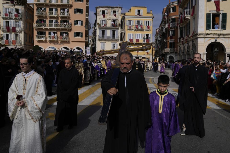 Residents watch the procession of the relics of Saint Spyridon, patron saint of Corfu, during Easter celebrations on the Ionian Sea island of Corfu, northwestern Greece, on Saturday, April 23, 2022. For the first time in three years, Greeks were able to celebrate Easter without the restrictions made necessary by the coronavirus pandemic. (AP Photo/Thanassis Stavrakis)