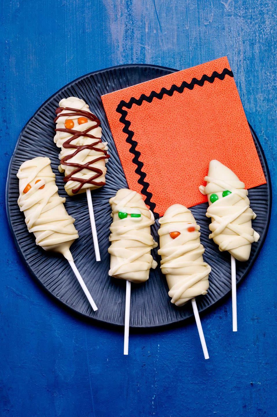 <p>The kids don't have any more excuses not to eat bananas after they see this mummified treat.</p><p>Get the <strong><a href="https://www.womansday.com/food-recipes/food-drinks/recipes/a12930/banana-mummies-recipe-wdy1014/" rel="nofollow noopener" target="_blank" data-ylk="slk:Banana Mummy Pops recipe;elm:context_link;itc:0;sec:content-canvas" class="link ">Banana Mummy Pops recipe</a></strong>.</p>