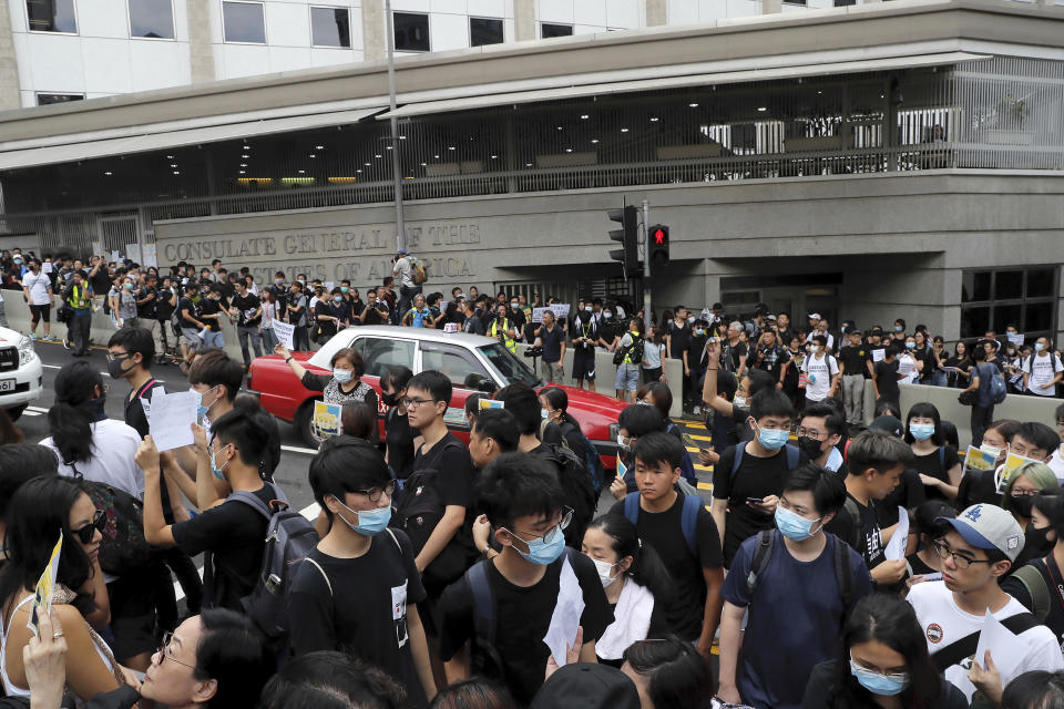 Protesters gather outside the U.S. Consulate to stage a protest in Hong Kong, Wednesday, June 26, 2019. Hong Kong activists opposed to contentious extradition legislation on Wednesday called on leaders of the U.S., the European Union and others to raise the issue with Chinese President Xi Jinping at this week's G-20 summit in Japan. (AP Photo/Kin Cheung)