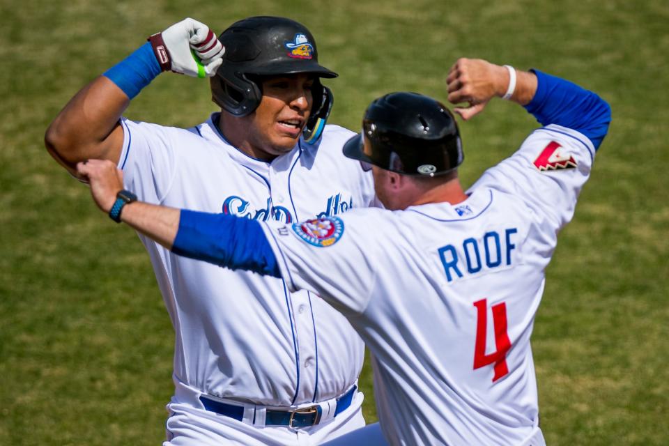 Amarillo Sod Poodles infielder Leandro Cedeno (35) celebrates with Amarillo Sod Poodles manager Shawn Roof (4) against the Midland RockHounds on Sunday, April 10, 2022, at HODGETOWN in Amarillo, Texas.