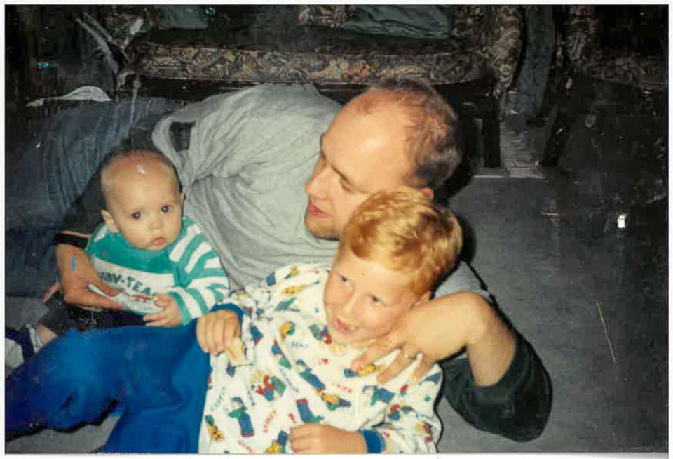 Louie Johnston, seven, plays with his brother Joshua, three, and their father David at their family home (Family handout/PA)