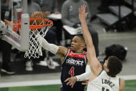 Washington Wizards' Russell Westbrook (4) goes to the hoop against Milwaukee Bucks' Brook Lopez during the first half of an NBA basketball game Wednesday, May 5, 2021, in Milwaukee. (AP Photo/Aaron Gash)