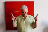 FILE - This Oct. 29, 2009 file photo shows Father Bill Moore in his studio at the Pomona Arts Colony in Pomona, Calif. Father Bill Moore, a Catholic priest and prominent abstract expressionist who spent decades spreading spiritualism through his paintings, has died. He was 71. Longtime friend Tom Irwin says Moore died Sunday, Oct. 18, 2020 of prostate cancer. Seeing his artistic talent, Moore's Southern California parish, the Sacred Hearts of Jesus and Mary, allowed him to spend much of his time painting. (AP Photo/Damian Dovarganes, File)