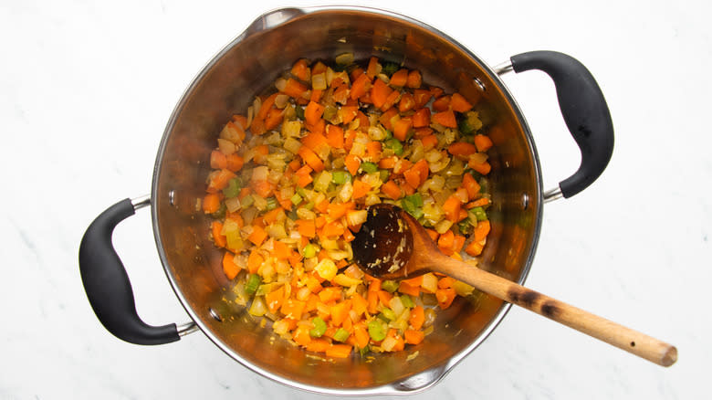 vegetables sauteeing in soup pot