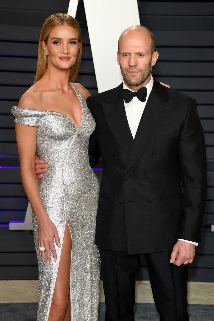 Jason Statham and Rosie Huntington-Whiteley posing on the Vanity Fair red carpet