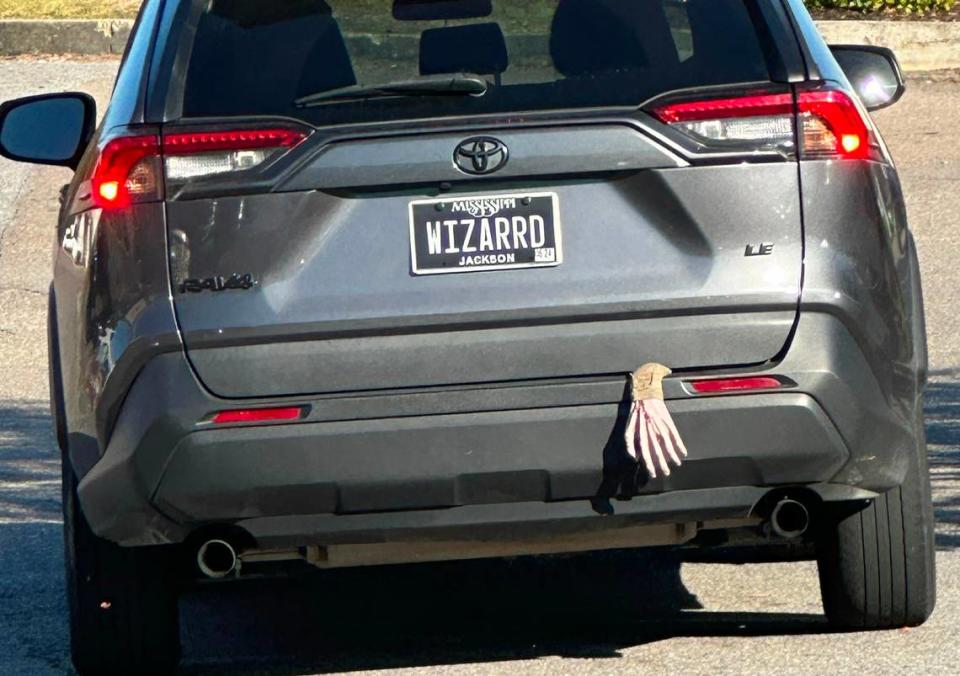 The fake hand hanging out the back just adds to the spookiness of this “WIZARRD” license plate. Hannah Ruhoff/Sun Herald