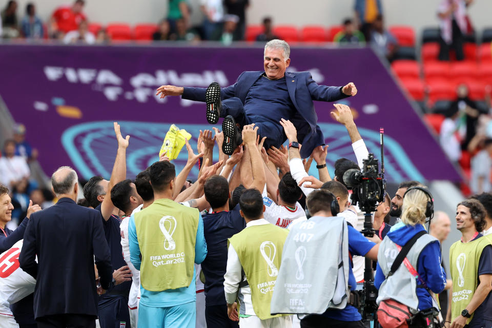 DOHA, QATAR - NOVEMBER 25: Carlos Queiroz head coach of Iran and Players of Iran celebrate after wining during the FIFA World Cup Qatar 2022 Group B match between Wales and IR Iran at Ahmad Bin Ali Stadium on November 25, 2022 in Doha, Qatar. (Photo by Maryam Majd ATPImages/Getty Images)