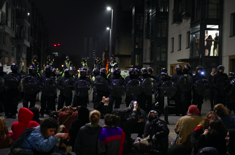 Police and protesters in Bristol face each other during a second night of demonstrations. (SWNS)