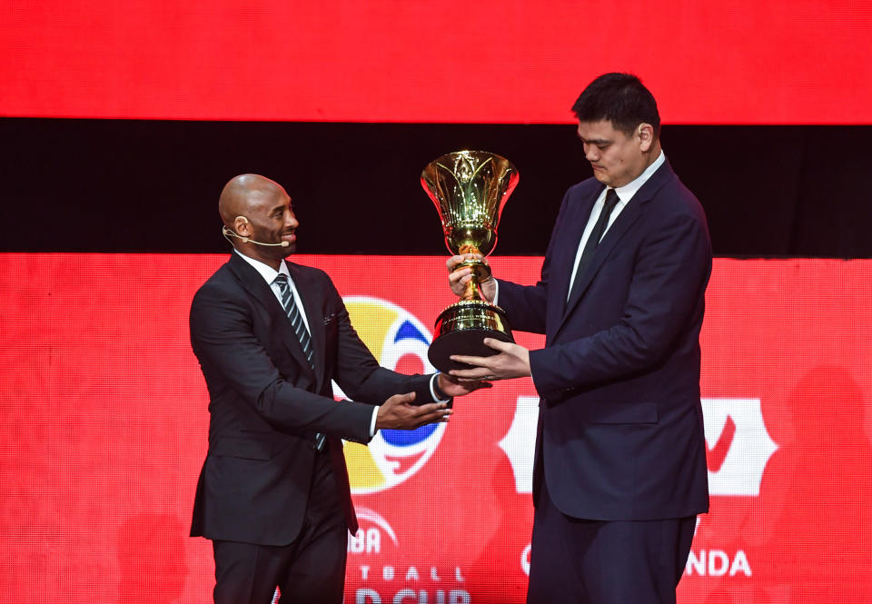 SHENZHEN, March 16, 2019 -- Kobe Bryant L, World Cup Ambassador hands over the World Cup Trophy to Yao Ming, president of the Chinese Basketball Association during the draw ceremony of 2019 FIBA Basketball World Cup in Shenzhen, south China's Guangdong Province, March 16, 2019. (Xinhua/Mao Siqian) (Xinhua/ via Getty Images)
