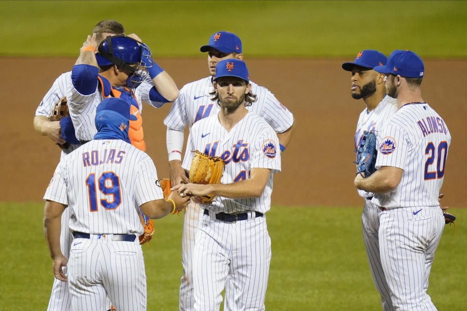 New York Mets relief pitcher Chasen Shreve (47) hands the ball to manager Luis Rojas (19) as he leaves the game during the eighth inning of a baseball game against the Tampa Bay Rays Wednesday, Sept. 23, 2020, in New York. (AP Photo/Frank Franklin II)