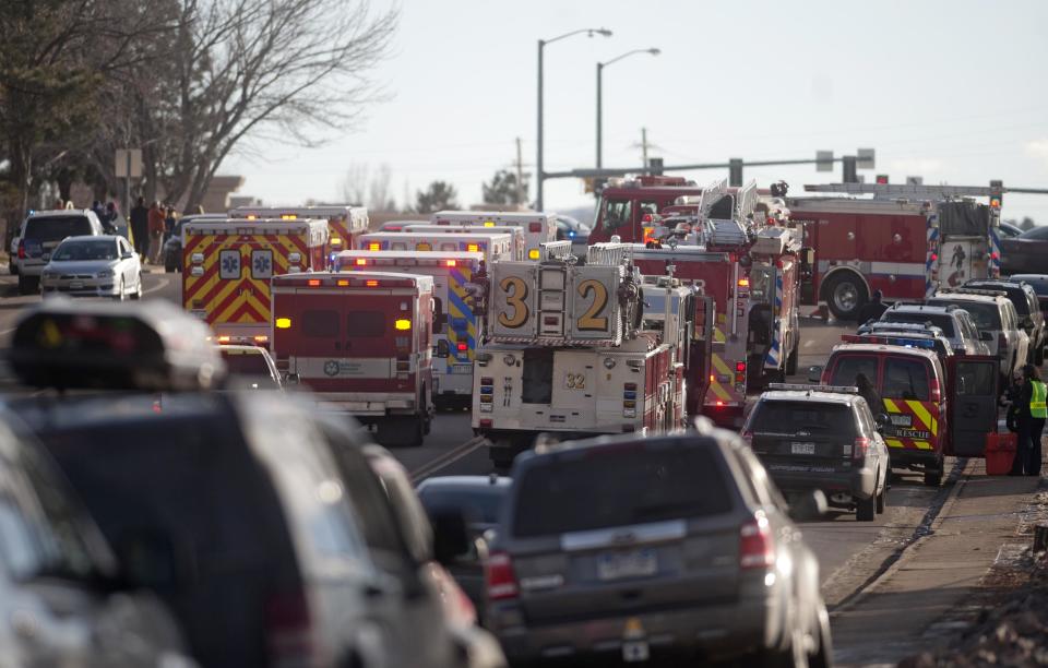 Rescue workers and officers make their way to Arapahoe High School, after a student opened fire in the school in Centennial, Colorado December 13, 2013. The student seeking to confront one of his teachers opened fire at the Colorado high school on Friday, wounding at least two classmates before apparently taking his own life, law enforcement officials said. REUTERS/Evan Semon (UNITED STATES - Tags: EDUCATION CRIME LAW)