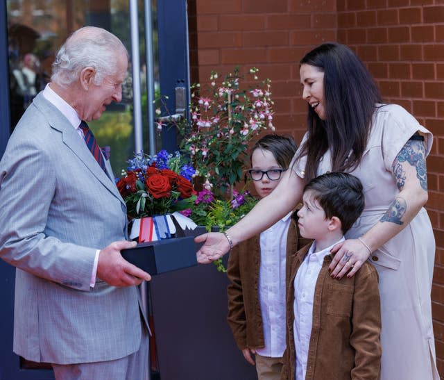 Charles receives gifts of flowers and Royal Engineer china mugs