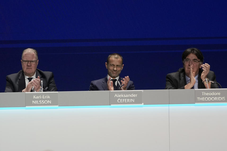 Aleksander Ceferin, center, president of UEFA, applauds during the 47th ordinary UEFA congress in Lisbon, Wednesday, April 5, 2023. (AP Photo/Armando Franca)