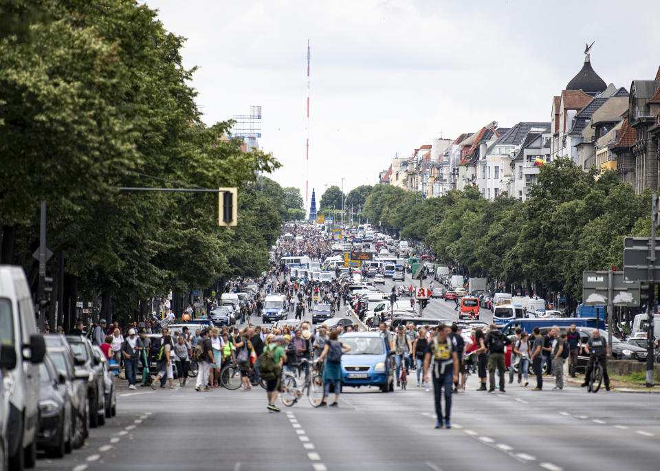 Demonstrators walk along Bismarckstrasse in Berlin, Sunday Aug. 1, 2021, during a protest against coronavirus restrictions. (Fabian Sommer/dpa via AP)