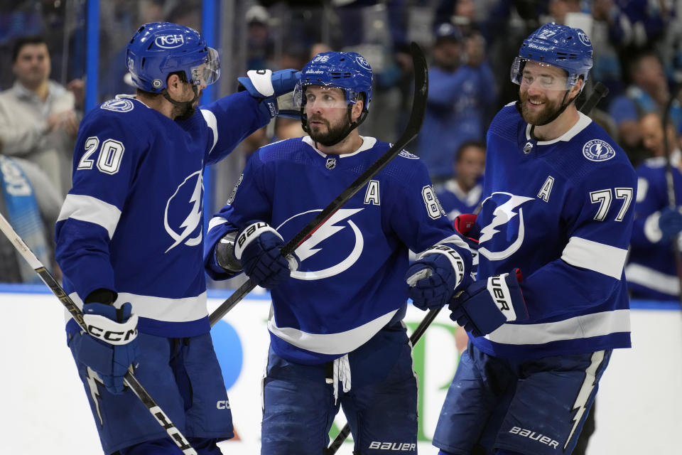 Tampa Bay Lightning right wing Nikita Kucherov (86) celebrates his goal against the Pittsburgh Penguins with left wing Nicholas Paul (20) and defenseman Victor Hedman (77) during the second period of an NHL hockey game Wednesday, Dec. 6, 2023, in Tampa, Fla. (AP Photo/Chris O'Meara)